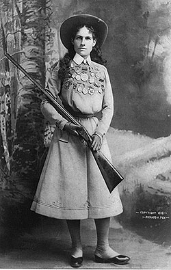 Full legnth portrait of Annie Oakley holding her gun