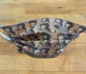 Photo of a facemask with a repeating image of Annie Oakley